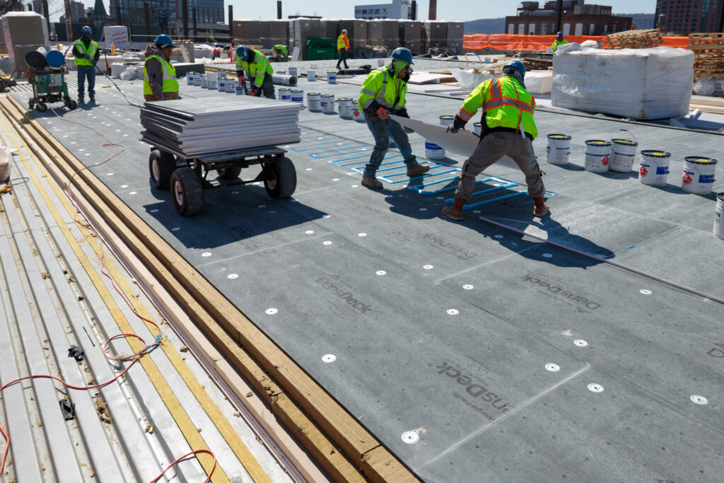 DensDeck Roof Board being installed on flat roof