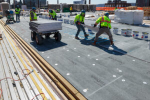 DensDeck Roof Board being installed on flat roof